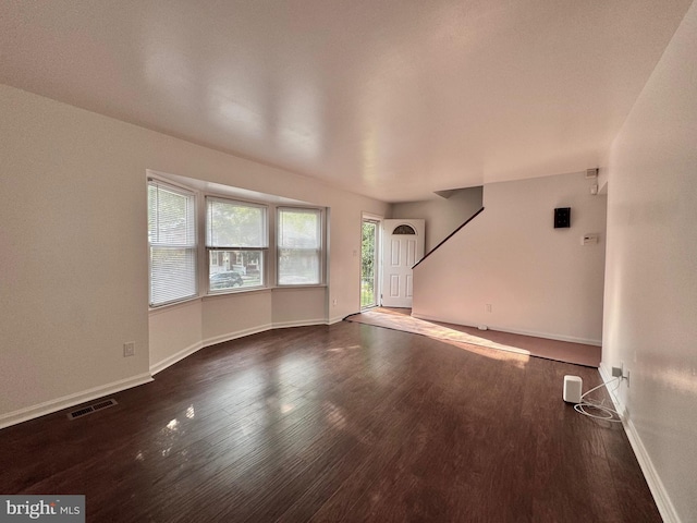 225 N New St, Dover, DE 19904 - unfurnished living room with wood finished floors and baseboards