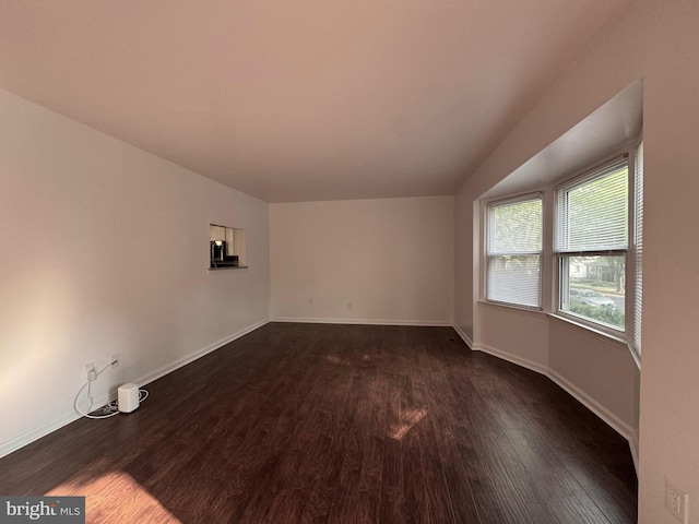225 N New St, Dover, DE 19904 - empty room with dark wood-style flooring and baseboards