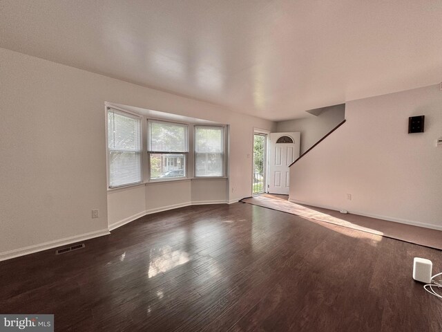 225 N New St, Dover, DE 19904 - unfurnished living room with wood finished floors and baseboards