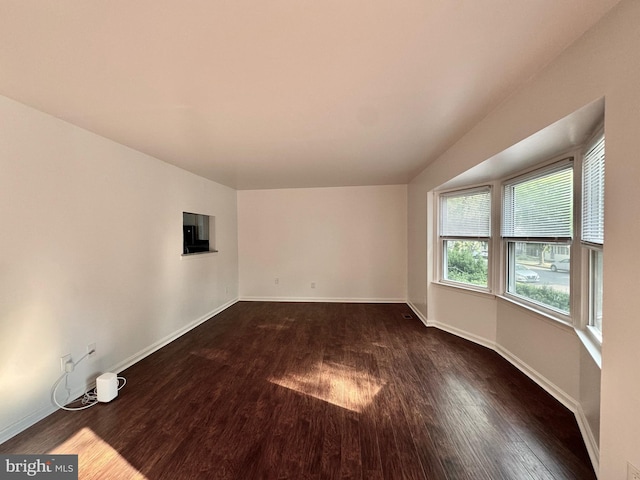 225 N New St, Dover, DE 19904 - empty room with dark wood-type flooring