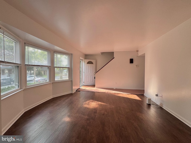 225 N New St, Dover, DE 19904 - unfurnished living room with wood finished floors and baseboards