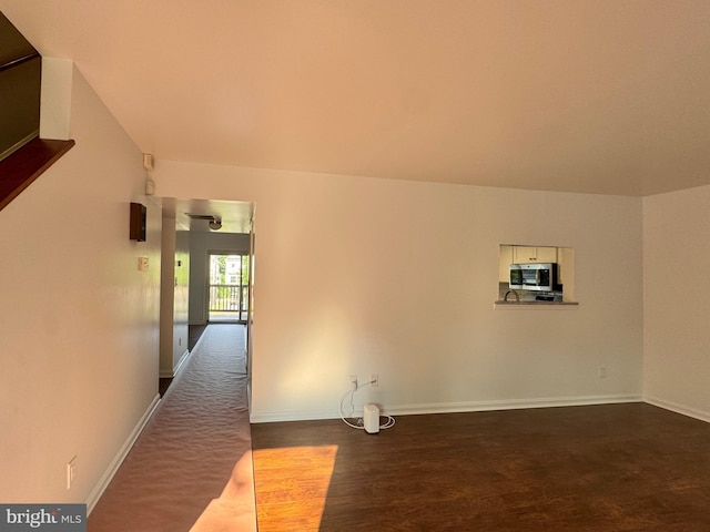 225 N New St, Dover, DE 19904 - spare room featuring dark wood-type flooring and baseboards