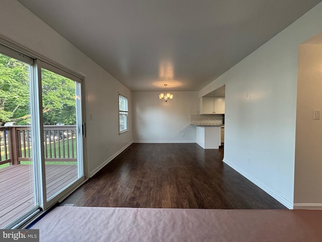 225 N New St, Dover, DE 19904 - unfurnished living room with a chandelier and wood finished floors