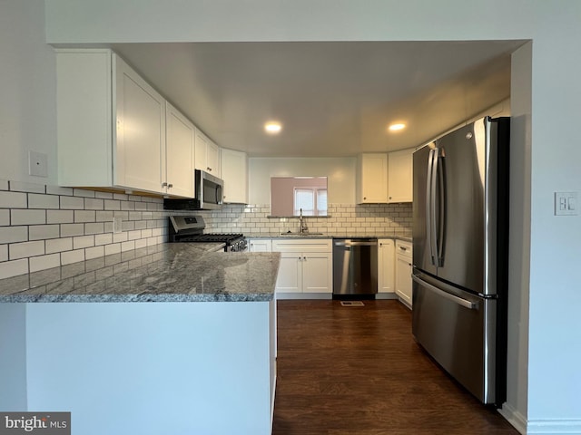 225 N New St, Dover, DE 19904 - kitchen featuring appliances with stainless steel finishes, dark wood finished floors, backsplash, white cabinetry, and recessed lighting