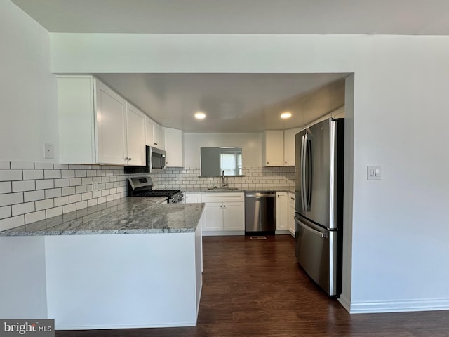 225 N New St, Dover, DE 19904 - kitchen featuring stainless steel appliances, dark wood-type flooring, backsplash, white cabinetry, and recessed lighting