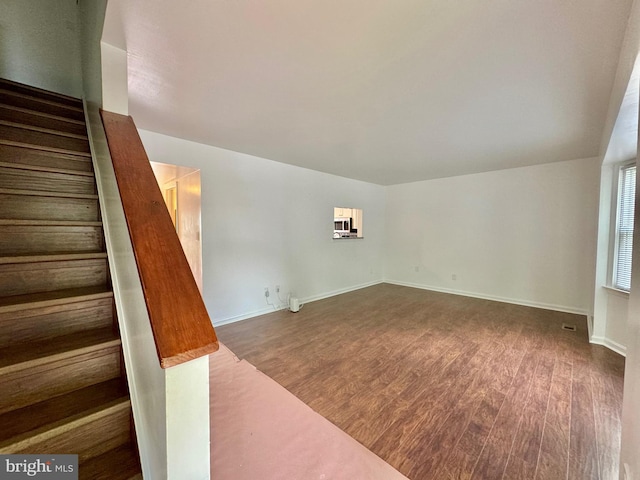 225 N New St, Dover, DE 19904 - unfurnished living room with stairs and wood finished floors