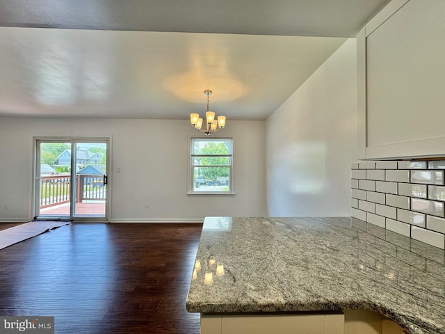 225 N New St, Dover, DE 19904 - unfurnished dining area featuring plenty of natural light, dark wood-style floors, a chandelier, and lofted ceiling