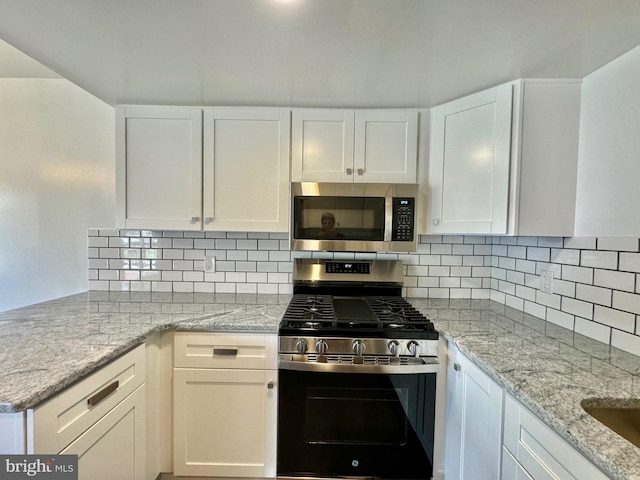 225 N New St, Dover, DE 19904 - kitchen featuring stainless steel appliances, white cabinetry, and light stone countertops