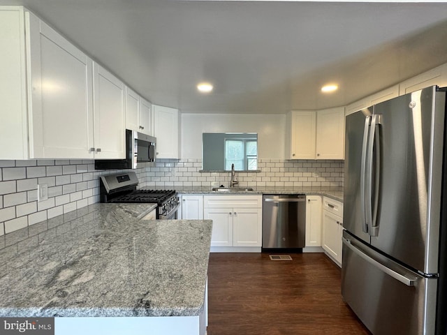 225 N New St, Dover, DE 19904 - kitchen featuring stainless steel appliances, tasteful backsplash, white cabinets, recessed lighting, and dark wood-style floors