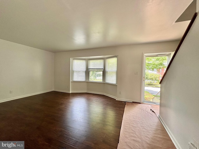 225 N New St, Dover, DE 19904 - unfurnished room featuring dark wood-type flooring and baseboards