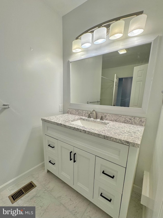 225 N New St, Dover, DE 19904 - bathroom featuring vanity, marble finish flooring, and a shower