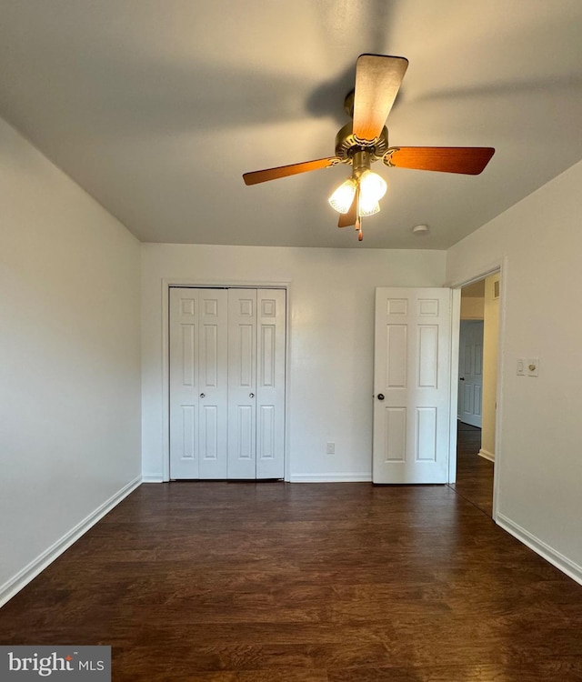 225 N New St, Dover, DE 19904 - unfurnished bedroom featuring dark wood-style flooring, a closet, and ceiling fan