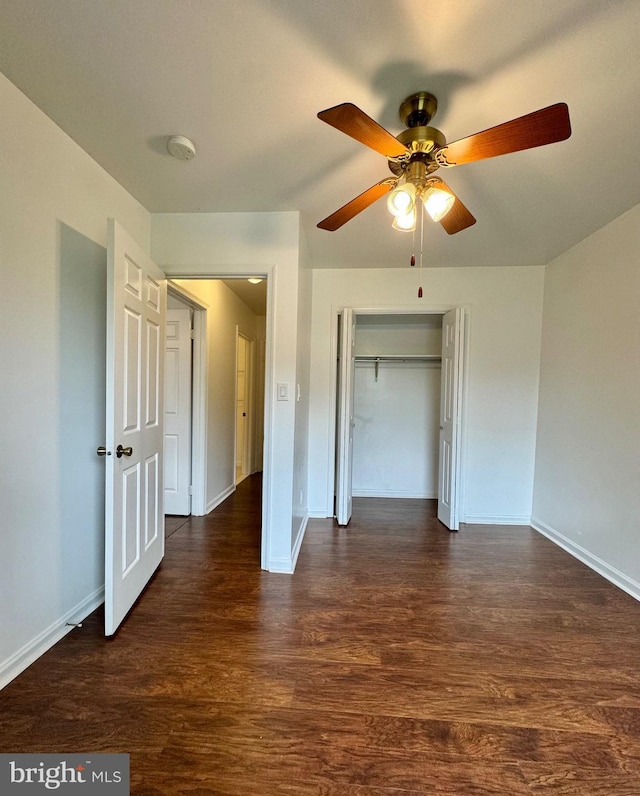 225 N New St, Dover, DE 19904 - unfurnished bedroom featuring dark wood-style floors, a closet, and a ceiling fan