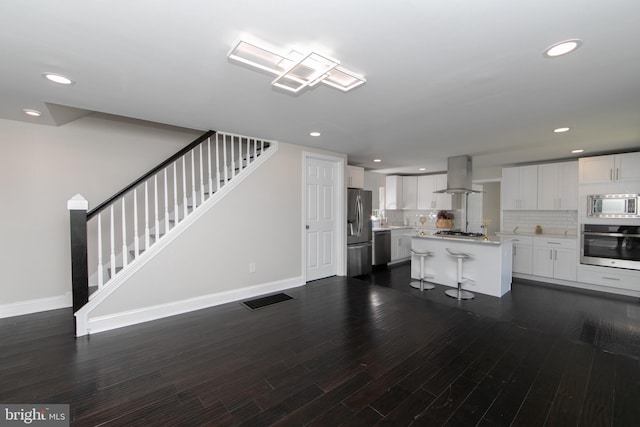 20 New St, Mullica Hill, NJ 08062 - kitchen featuring stainless steel appliances, island range hood, light countertops, tasteful backsplash, and dark wood-type flooring