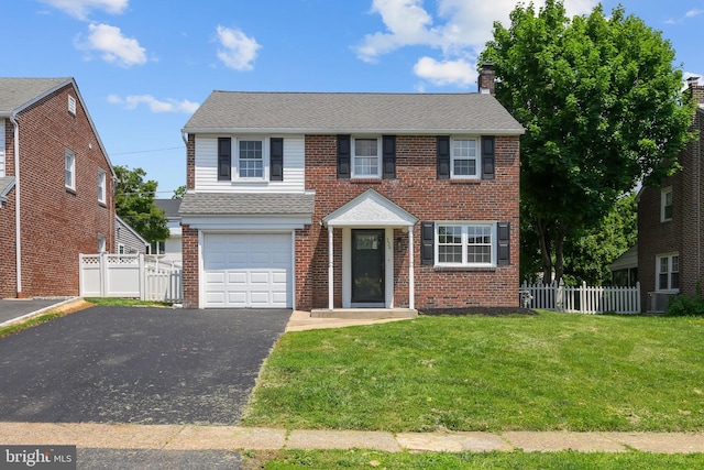 129 Flintlock Rd, Drexel Hill, PA 19026 - view of front of home featuring driveway, brick siding, a garage, and a chimney