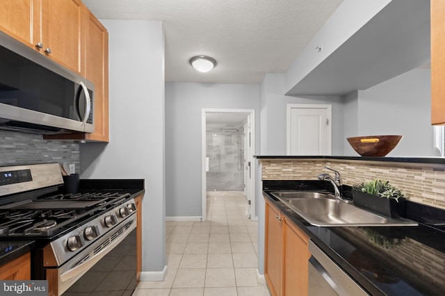 851 N Glebe Rd Unit 1508, Arlington, VA 22203 - kitchen with stainless steel appliances, decorative backsplash, dark countertops, light tile patterned flooring, and a textured ceiling