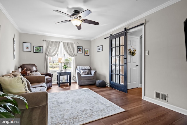 3 Adrian Pl, Newtown, PA 18940 - living area with ceiling fan, a barn door, dark wood-type flooring, ornamental molding, and baseboards