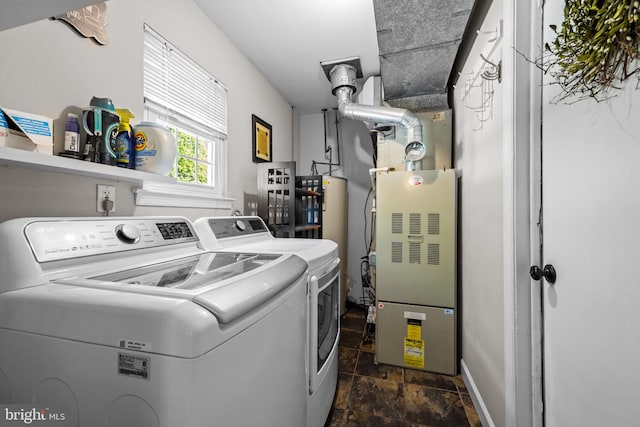 3 Adrian Pl, Newtown, PA 18940 - laundry room featuring washing machine and dryer, dark stone finish floors, water heater, and baseboards