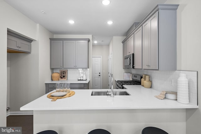714 Parker Blvd, Princeton Junction, NJ 08550 - kitchen featuring stainless steel appliances, gray cabinetry, backsplash, a peninsula, and recessed lighting