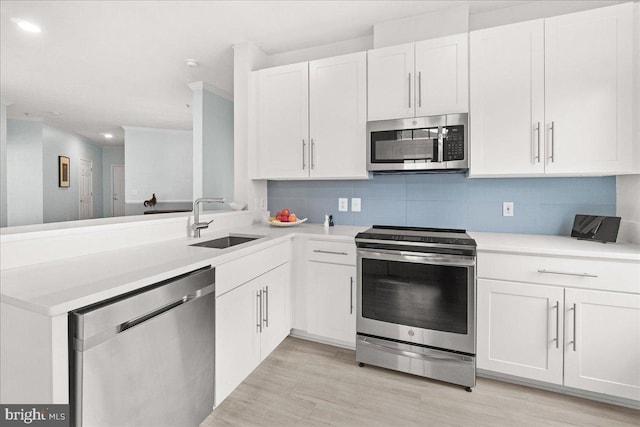 110 Chevy Chase St Unit 301, Gaithersburg, MD 20878 - kitchen with appliances with stainless steel finishes, a sink, white cabinetry, recessed lighting, and decorative backsplash