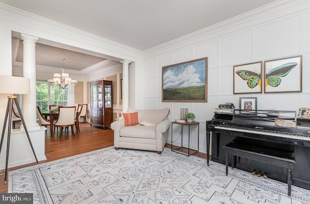 25 Crescent Links Dr, North East, MD 21901 - living area with ornate columns, light wood finished floors, crown molding, a chandelier, and a decorative wall