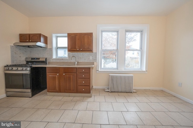 17 Elm Ave, Upper Darby, PA 19082 - kitchen with radiator heating unit, stainless steel range with gas stovetop, a sink, ventilation hood, and light countertops