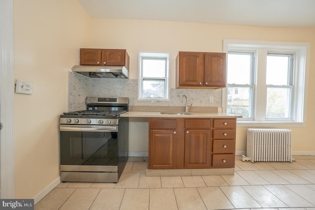 17 Elm Ave, Upper Darby, PA 19082 - kitchen featuring radiator, stainless steel gas stove, ventilation hood, a sink, and decorative backsplash