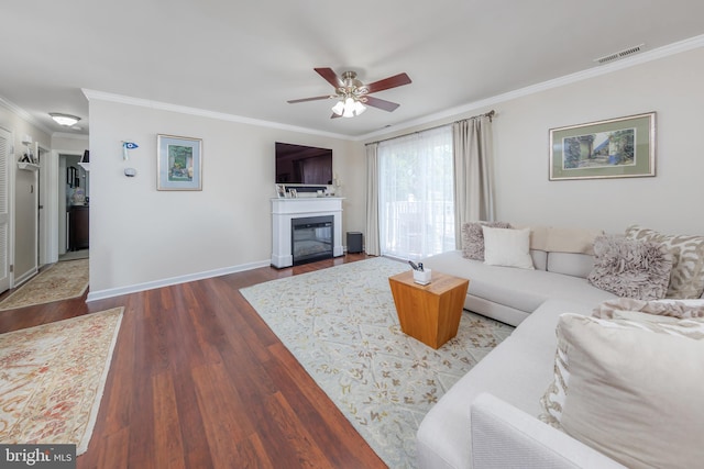 606 Yorkshire Ct, Sewell, NJ 08080 - living area with crown molding, wood finished floors, a ceiling fan, a glass covered fireplace, and baseboards