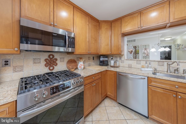 606 Yorkshire Ct, Sewell, NJ 08080 - kitchen featuring stainless steel appliances, a sink, and brown cabinetry