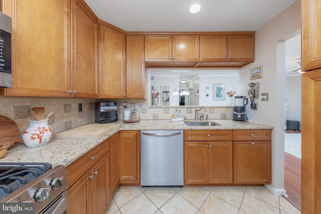 606 Yorkshire Ct, Sewell, NJ 08080 - kitchen with appliances with stainless steel finishes, a sink, light tile patterned flooring, tasteful backsplash, and brown cabinetry