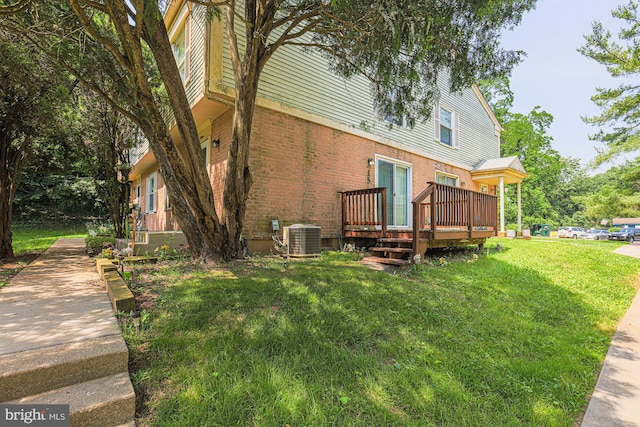 15 Woodenbridge Ct Unit C, Reisterstown, MD 21136 - view of side of home featuring brick siding, a lawn, and a wooden deck