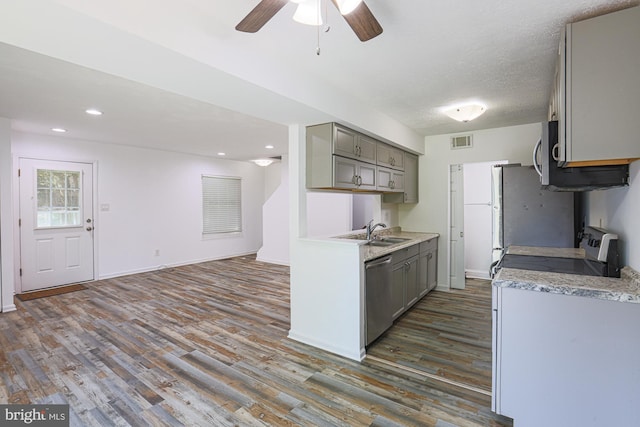15 Woodenbridge Ct Unit C, Reisterstown, MD 21136 - kitchen featuring gray cabinetry, stainless steel appliances, dark wood finished floors, light countertops, and ceiling fan