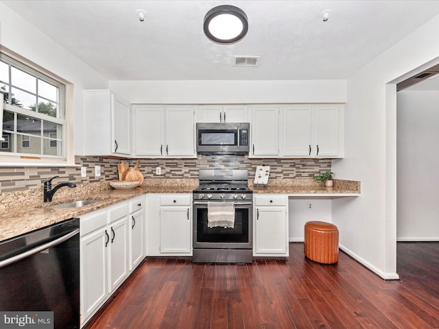 2482 Wentworth Dr Unit 2482, Crofton, MD 21114 - kitchen with stainless steel appliances, light stone counters, white cabinets, decorative backsplash, and dark wood finished floors