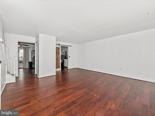 2482 Wentworth Dr Unit 2482, Crofton, MD 21114 - unfurnished living room featuring dark wood-style flooring, a barn door, and stairway