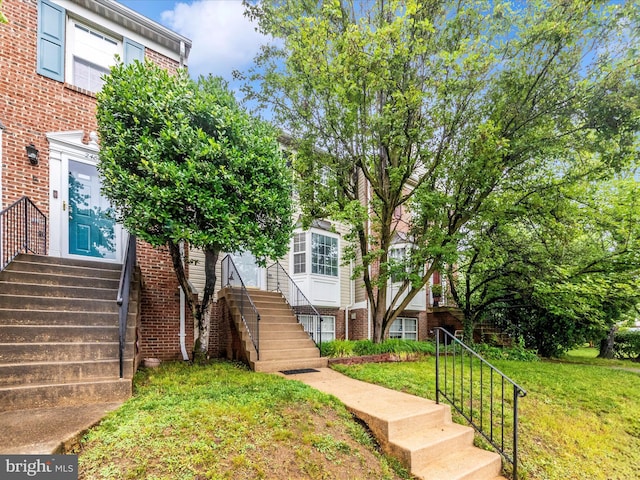 2482 Wentworth Dr Unit 2482, Crofton, MD 21114 - townhome / multi-family property featuring a front lawn, brick siding, entry steps, and stairway