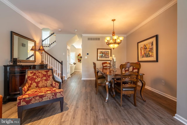 102 Warwick Way N, Wales, PA 19454 - dining room featuring wood finished floors, a chandelier, stairs, crown molding, and baseboards