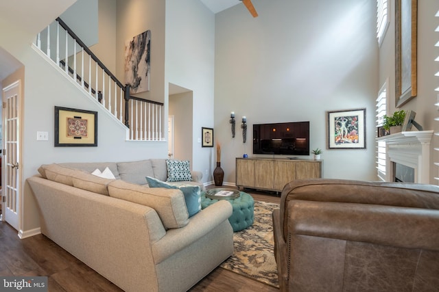 102 Warwick Way N, Wales, PA 19454 - living area featuring a high ceiling, wood finished floors, stairway, baseboards, and a fireplace
