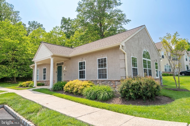 102 Warwick Way N, Wales, PA 19454 - view of front of home with stone siding, a front lawn, stucco siding, and a shingled roof