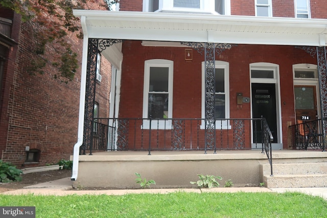 722 W King St, York, PA 17401 - doorway to property with a porch and brick siding