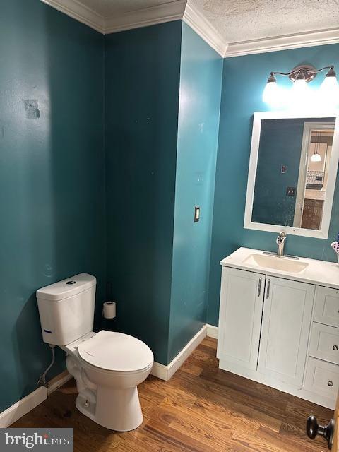 121 Defense Ct, Hedgesville, WV 25427 - half bath featuring toilet, crown molding, vanity, wood finished floors, and baseboards