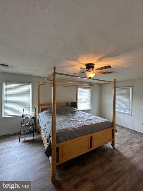 121 Defense Ct, Hedgesville, WV 25427 - bedroom with a textured ceiling, wood finished floors, a ceiling fan, and baseboards