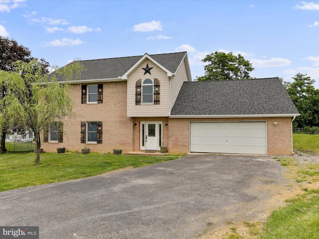 121 Defense Ct, Hedgesville, WV 25427 - view of front of home featuring driveway, a garage, a front yard, and brick siding