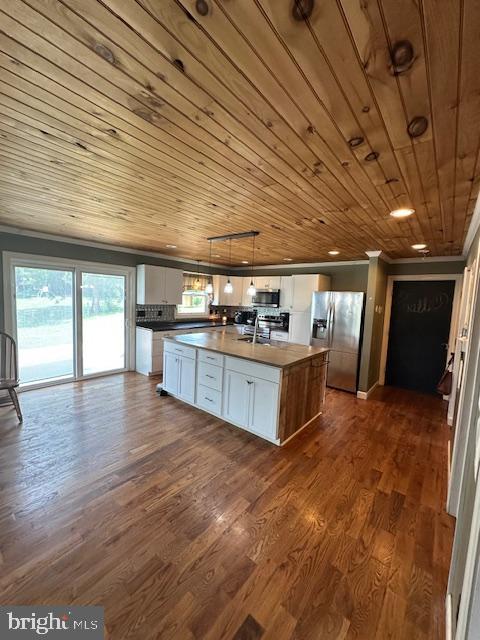 121 Defense Ct, Hedgesville, WV 25427 - kitchen featuring stainless steel appliances, white cabinets, wood ceiling, a center island with sink, and dark wood-type flooring