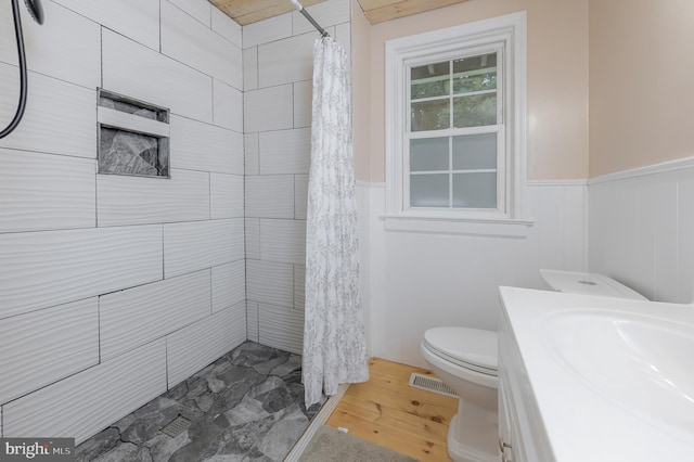 535 Friesburg Aldine, Elmer, NJ 08318 - bathroom featuring a wainscoted wall, a tile shower, wood finished floors, and vanity