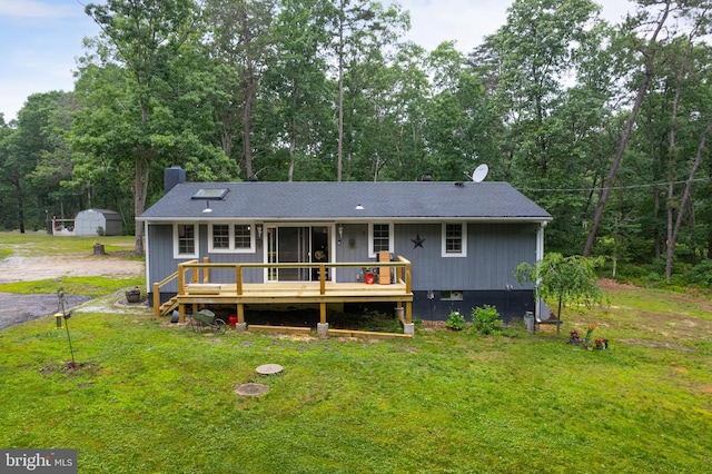 535 Friesburg Aldine, Elmer, NJ 08318 - view of front facade with a front yard, a deck, a chimney, and roof with shingles