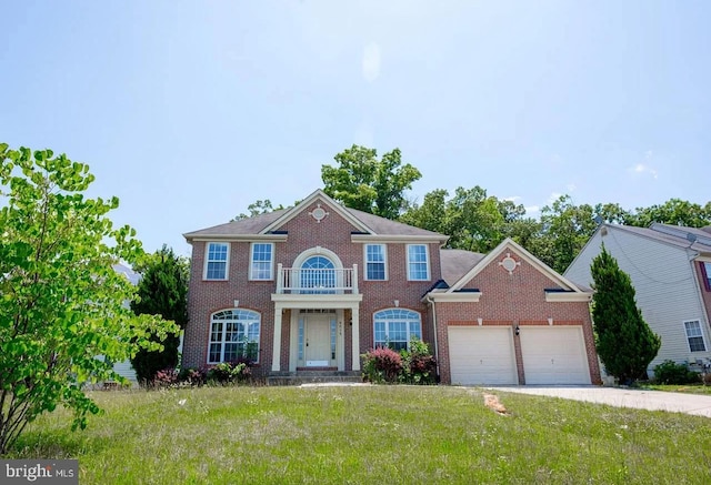 6215 Erland Way, Lanham, MD 20706 - georgian-style home featuring a balcony, a front yard, an attached garage, brick siding, and concrete driveway