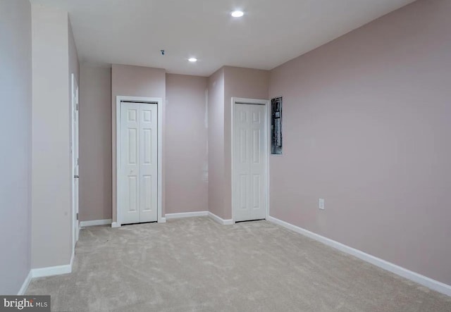6215 Erland Way, Lanham, MD 20706 - unfurnished bedroom featuring light carpet, baseboards, recessed lighting, and multiple closets
