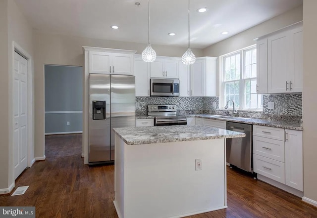 6215 Erland Way, Lanham, MD 20706 - kitchen featuring appliances with stainless steel finishes, a sink, white cabinetry, decorative backsplash, and a kitchen island