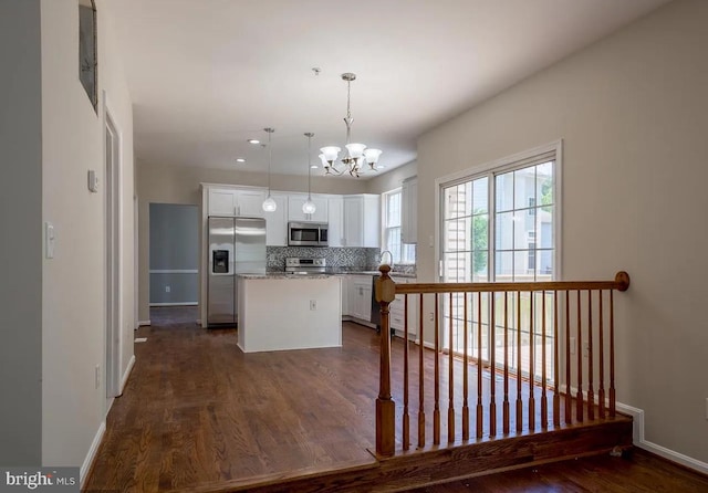 6215 Erland Way, Lanham, MD 20706 - kitchen with stainless steel appliances, white cabinetry, baseboards, dark wood finished floors, and a center island