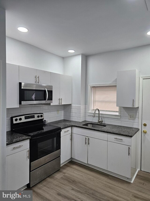 2249 Kennedy St, Philadelphia, PA 19137 - kitchen with stainless steel appliances, a sink, decorative backsplash, white cabinets, and recessed lighting